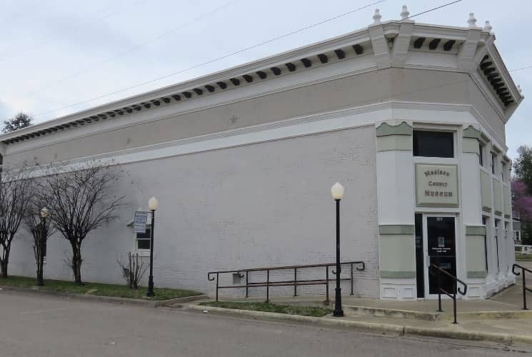 Large white brick building that houses the Madison County Museum